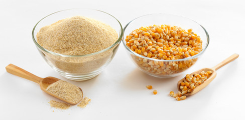 Glass bowls with flour and corn grains isolated on white