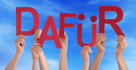 People Holding German Word Dafuer Means For It Blue Sky