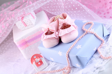 Pink baby boots with gift close-up