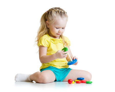 child playing with color pyramid toy