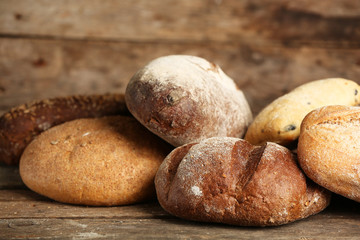 Different fresh bread on old wooden table