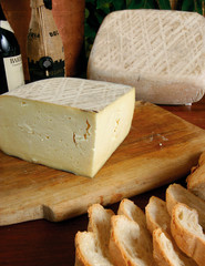 selection of italian cheese sliced on wood background