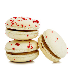 close up of colorful macaroons over white background