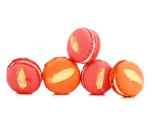 close up of colorful macaroons over white background