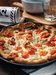 Quiche with soft cheese, artichokes and cherry tomatoes