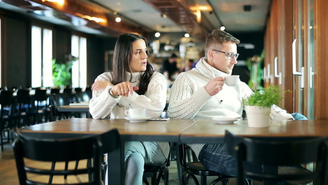 Unhappy couple sitting in the restaurant after quarrel
