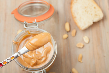 raw organic creamy peanut butter on knife