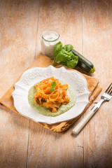 tomato tagliatelle over zucchinis pesto sauce