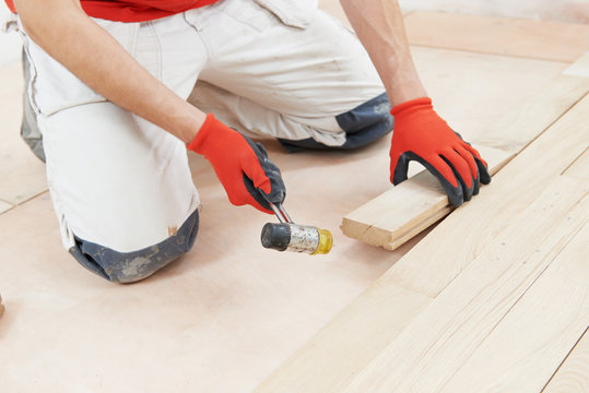 carpenter worker joining parket floor