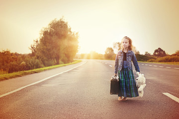 Youthful girl in retro style with old suitcase