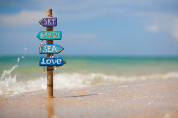Handmade signpost on the tropical beach in Thailand.