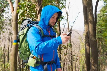 Fototapeten Bergsteigen Hiker using Mobile phone  © Stock Rocket