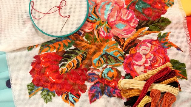 Bright embroidery with flowers, flosses thread and hoop