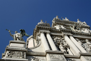 Historic church exterior with a lot of sculptures, in Venice.