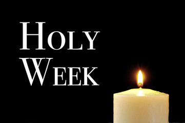 a lit candle and the text holy week