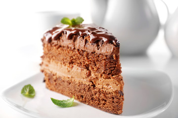 Fototapeta na wymiar Delicious chocolate cake on plate on table on light background