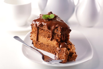Delicious chocolate cake on plate on table on light background