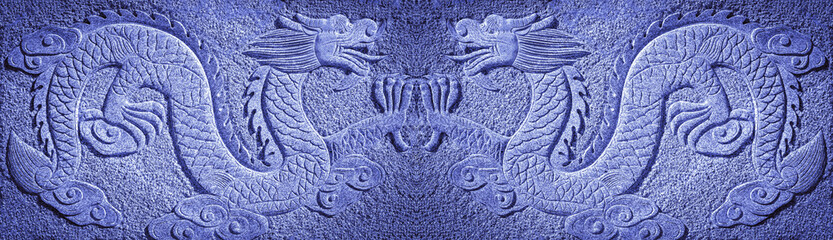 two Chinese blue dragons carved in the rock