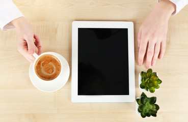 Hands working in the office with laptop, on wooden table