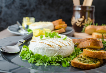 Grilled camembert with herbs, baquettes