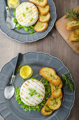 Grilled camembert with herbs, baquettes