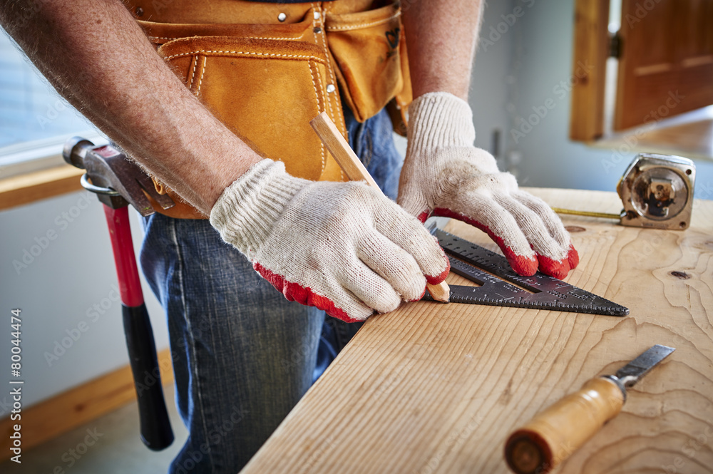 Wall mural carpenter making a measurement