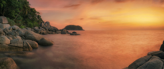 Sunset in phuket beach with rock