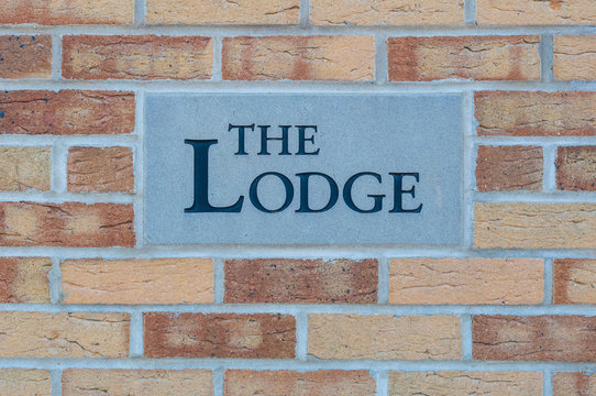 Sign 'The Lodge' on a brick wall