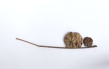 Coconut shell elephant walking on the dry branch