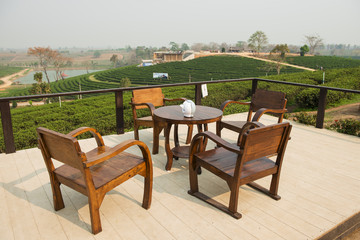 wooden table tea and tea plantation background at Choui Fong