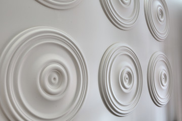Round white stucco on the wall