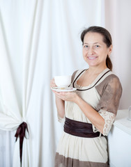 mature woman in   white room.