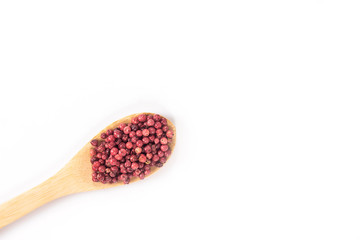 isolated red peppercorn on wooden spoon