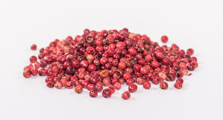 pile of red peppercorn isolated on white