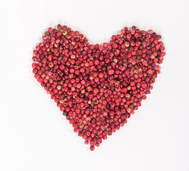 isolated heart laid out from the red peppercorns