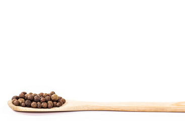 isolated black pepper on wooden spoon