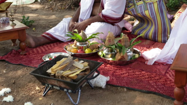 wedding accessories lay near hindu bramin on indian wedding