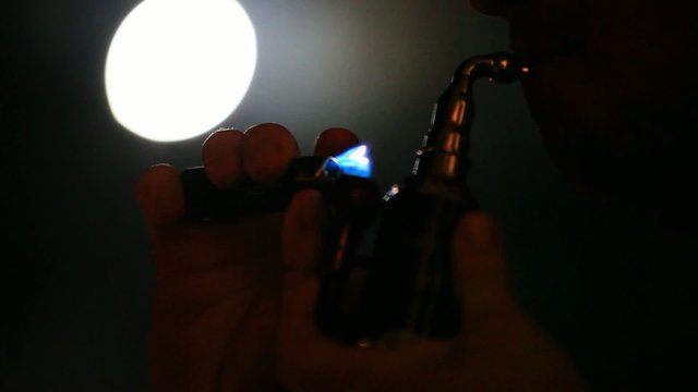 Man smoking water pipe on the moon background. Changes focus On