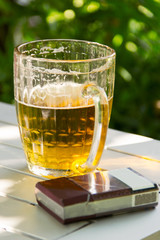mug of beer and cigarettes summer day on nature