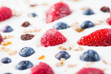 fresh berries fruits isolated on greek yogurt, healthy backgroun
