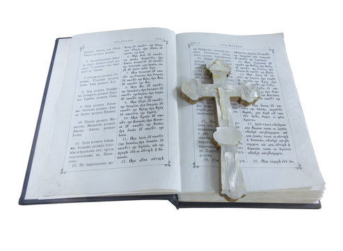19th Century old bible and cross isolated over white
