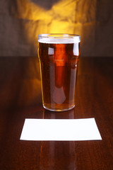Pint of beer and note