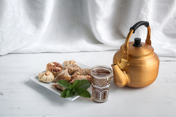 Arabic teapot on white wooden table