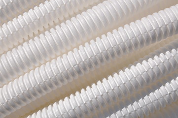 White plastic corrugated pipe as background