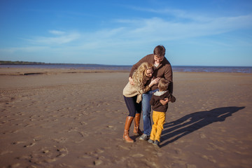 The parents and the son are embracing one another