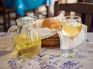 Wine and bread on a table in restaurant on Lefkada