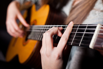 Fototapeta na wymiar Woman playing accoustic guitar