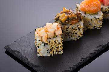 Sushi rolls on a stone plate