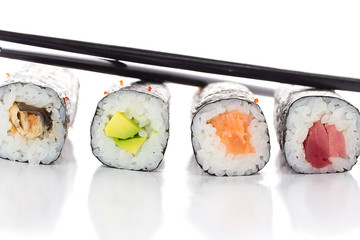 Sushi maki with chopsticks isolated on white background © z10e