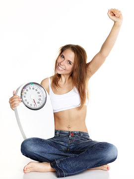 Girl with scale is proud to lose weight